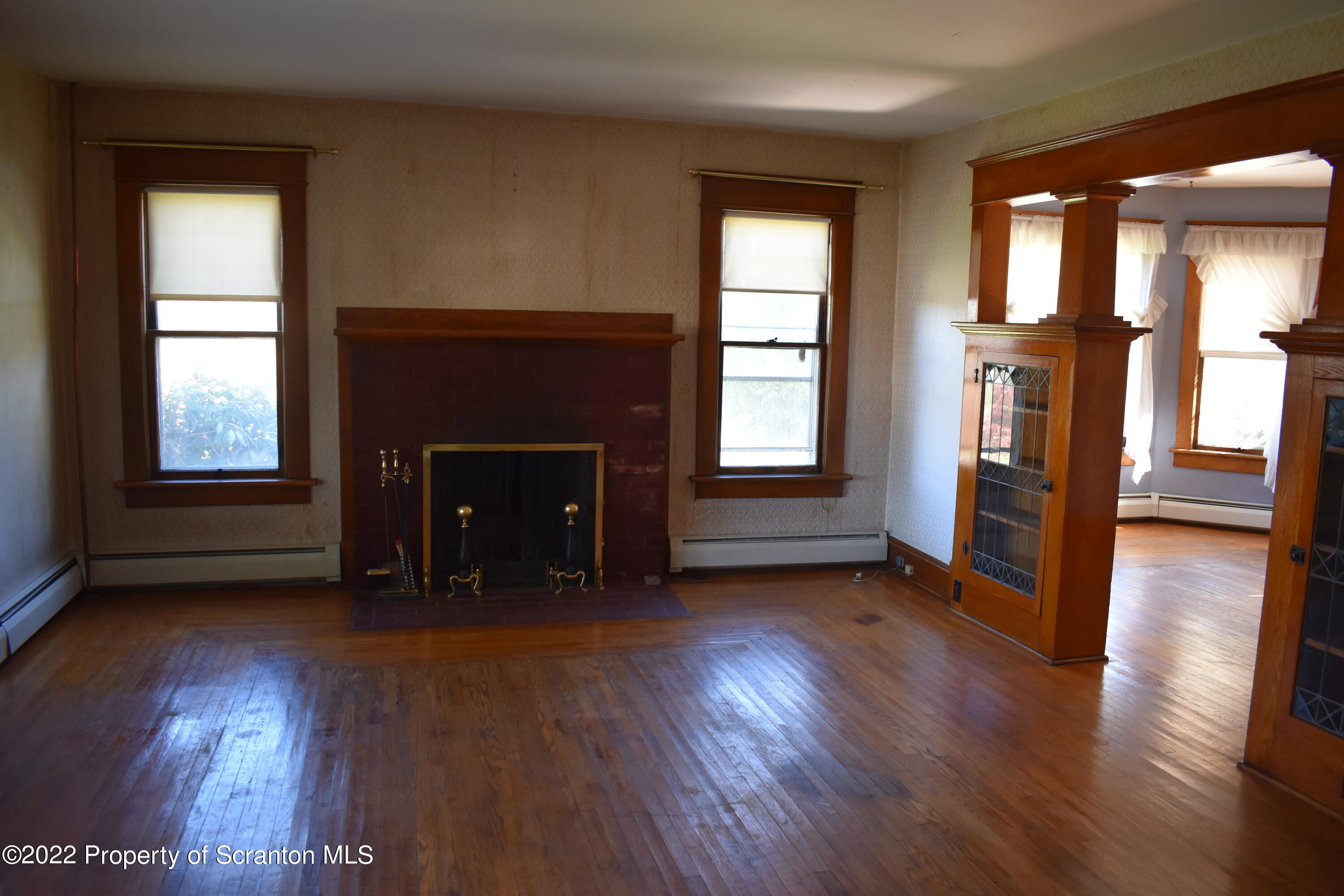 15850 State Rte 3001 Montrose, PA 18801 - Photo 12 of 66 an empty room with wooden floor fireplace and windows