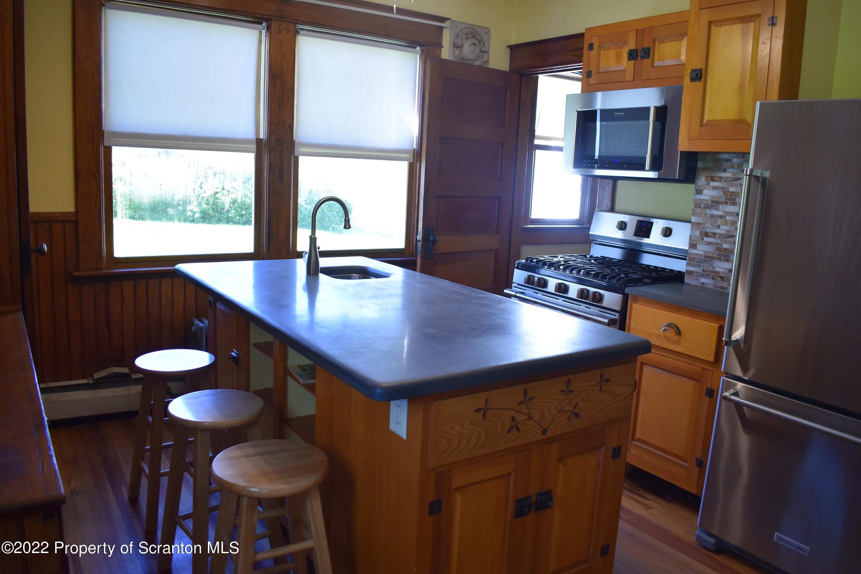 15850 State Rte 3001 Montrose, PA 18801 - Photo 7 of 66 a kitchen with a table chairs a stove and a refrigerator