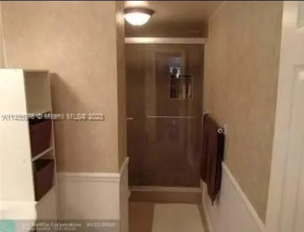 a bathroom with a shower and a toilet