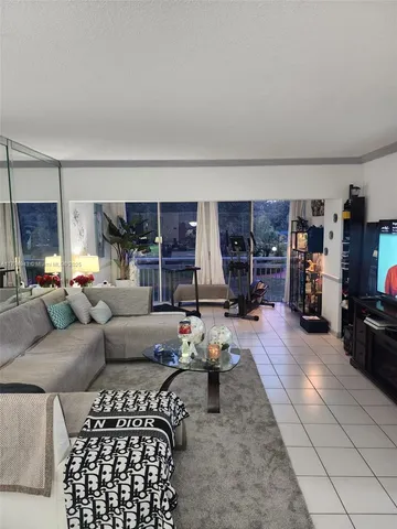 a living room with furniture and a gym machine