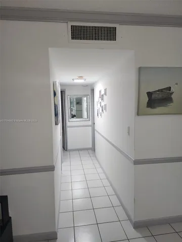 a bedroom with a bed and a lamp