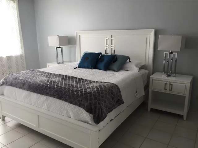 a bedroom with a bed and a night stand