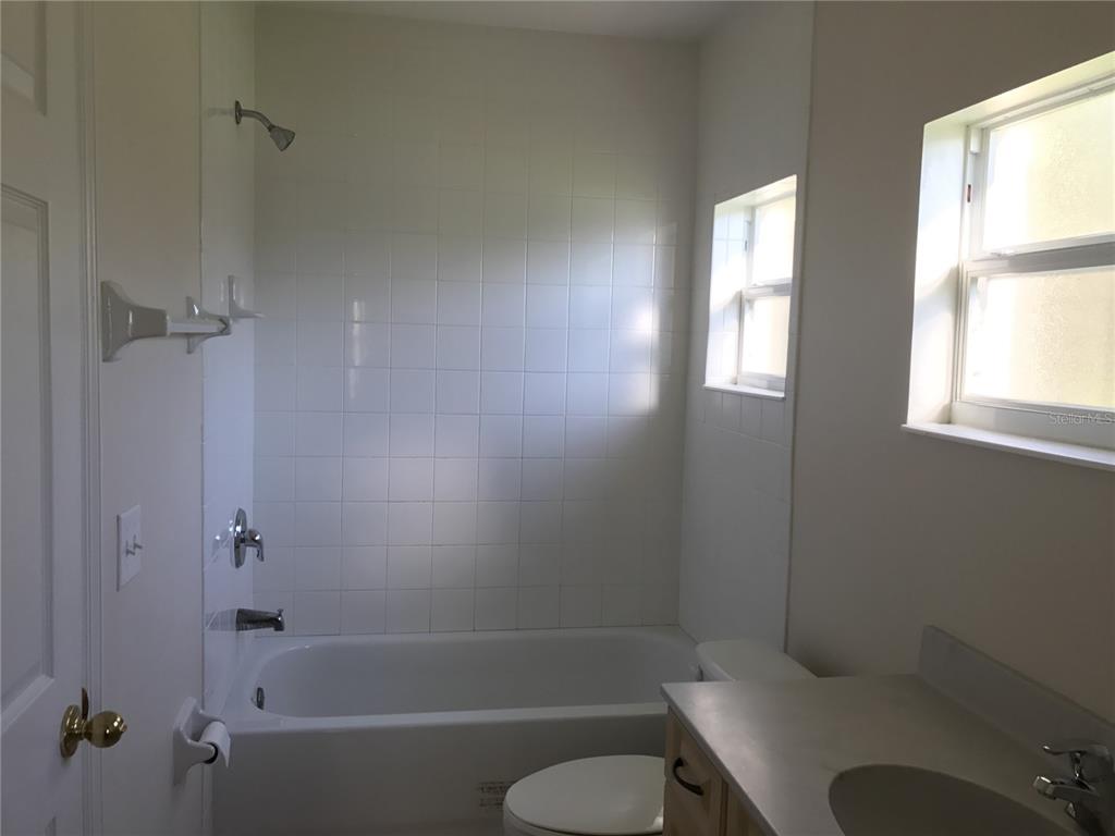 1001 Aultman Road Kissimmee, FL 34744 - Photo 11 of 17 a bath room with a toilet and a bath tub