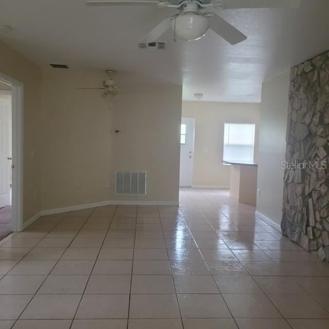 1001 Aultman Road Kissimmee, FL 34744 - Photo 7 of 17 an empty room with a ceiling fan and a window