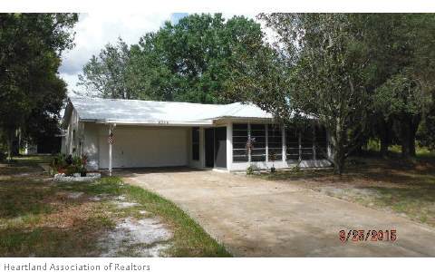 4356 Skipper Road Sebring, FL 33875 - Photo 1 of 16 a house with trees in the background