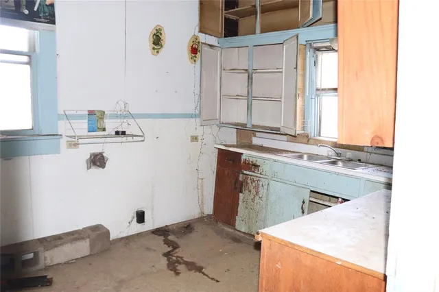 a kitchen with a sink cabinets and window