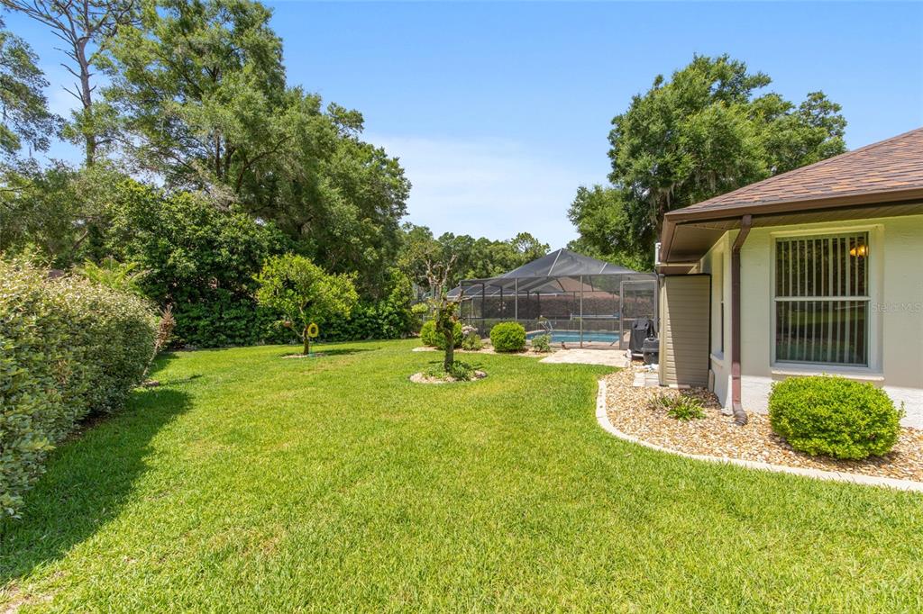 18825 Southwest 93rd Loop Dunnellon, FL 34432 - Photo 59 of 85 a view of a backyard with table and chairs and potted plants