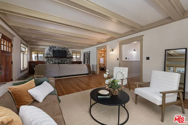 a kitchen with stainless steel appliances a dining table chairs and wooden floor