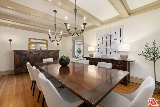 a kitchen that has a sink a stove and a wooden floor