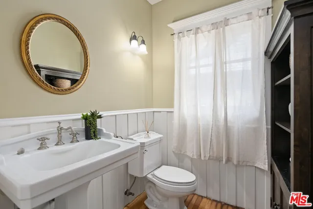 a bathroom with a sink toilet and mirror