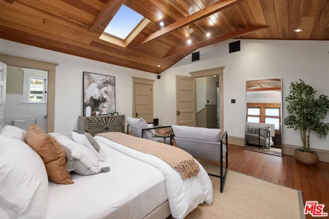 a bedroom with double bed and a large window