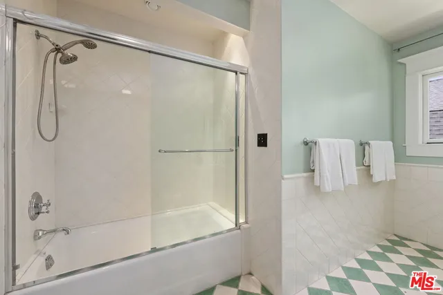 a bathroom with a tub shower and sink