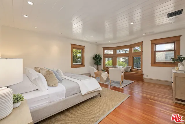 a view of a patio with table and chairs potted plants and wooden floor