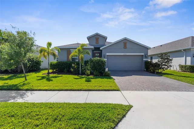 a front view of a house with a yard and garage