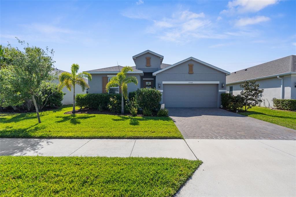 a front view of a house with a yard and garage