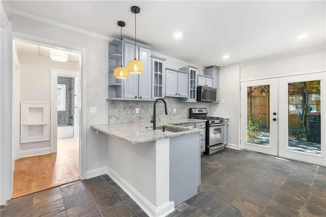 a kitchen with stainless steel appliances granite countertop a sink stove and refrigerator