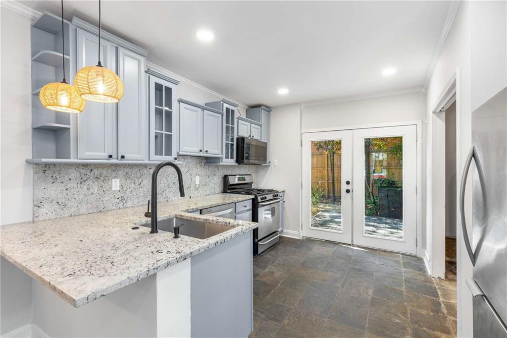216 Haralson Avenue Northeast Atlanta, GA 30307 - Photo 14 of 34 a kitchen with stainless steel appliances granite countertop a sink stove and refrigerator