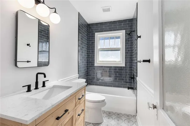 a bathroom with a sink toilet tub and shower