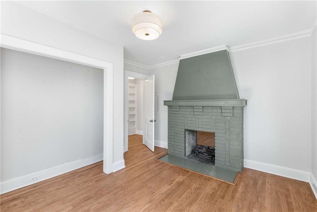 216 Haralson Avenue Northeast Atlanta, GA 30307 - Photo 21 of 34 a view of an empty room with wooden floor and fireplace
