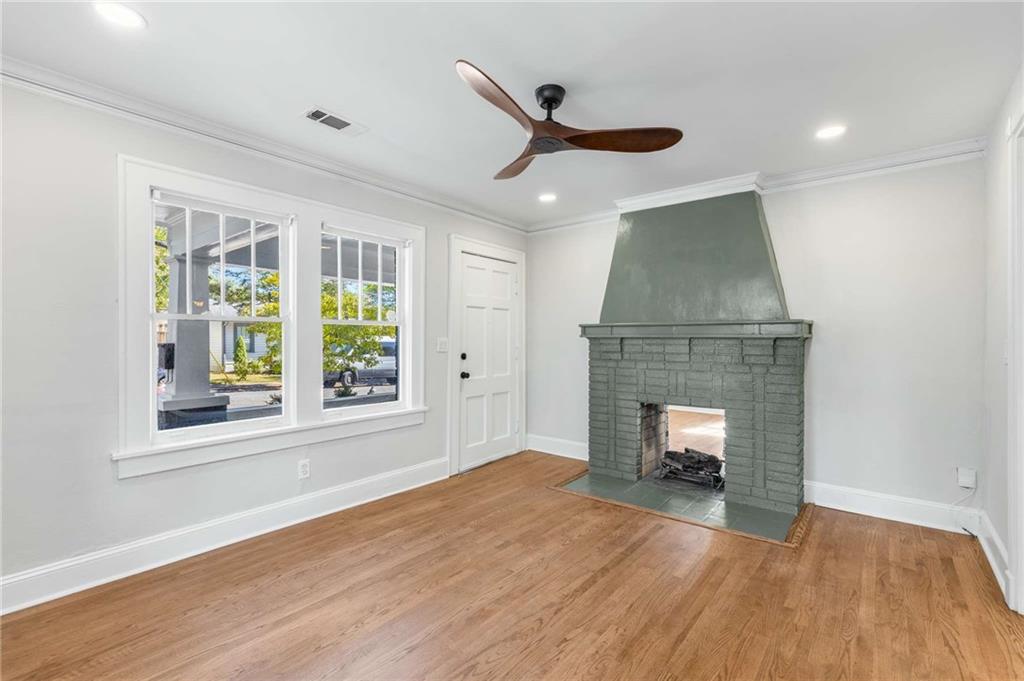 216 Haralson Avenue Northeast Atlanta, GA 30307 - Photo 10 of 34 a view of an empty room with wooden floor fireplace and a window