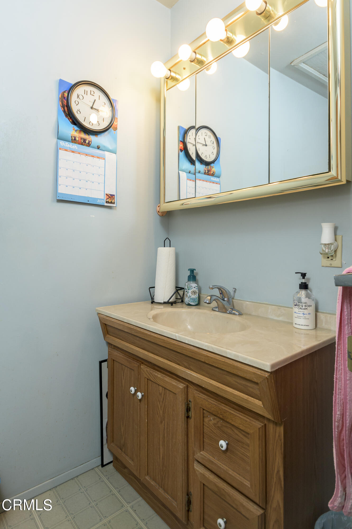 3279 Laurice Avenue Altadena, CA 91001 - Photo 16 of 24 a utility room with a sink a clock and cabinets