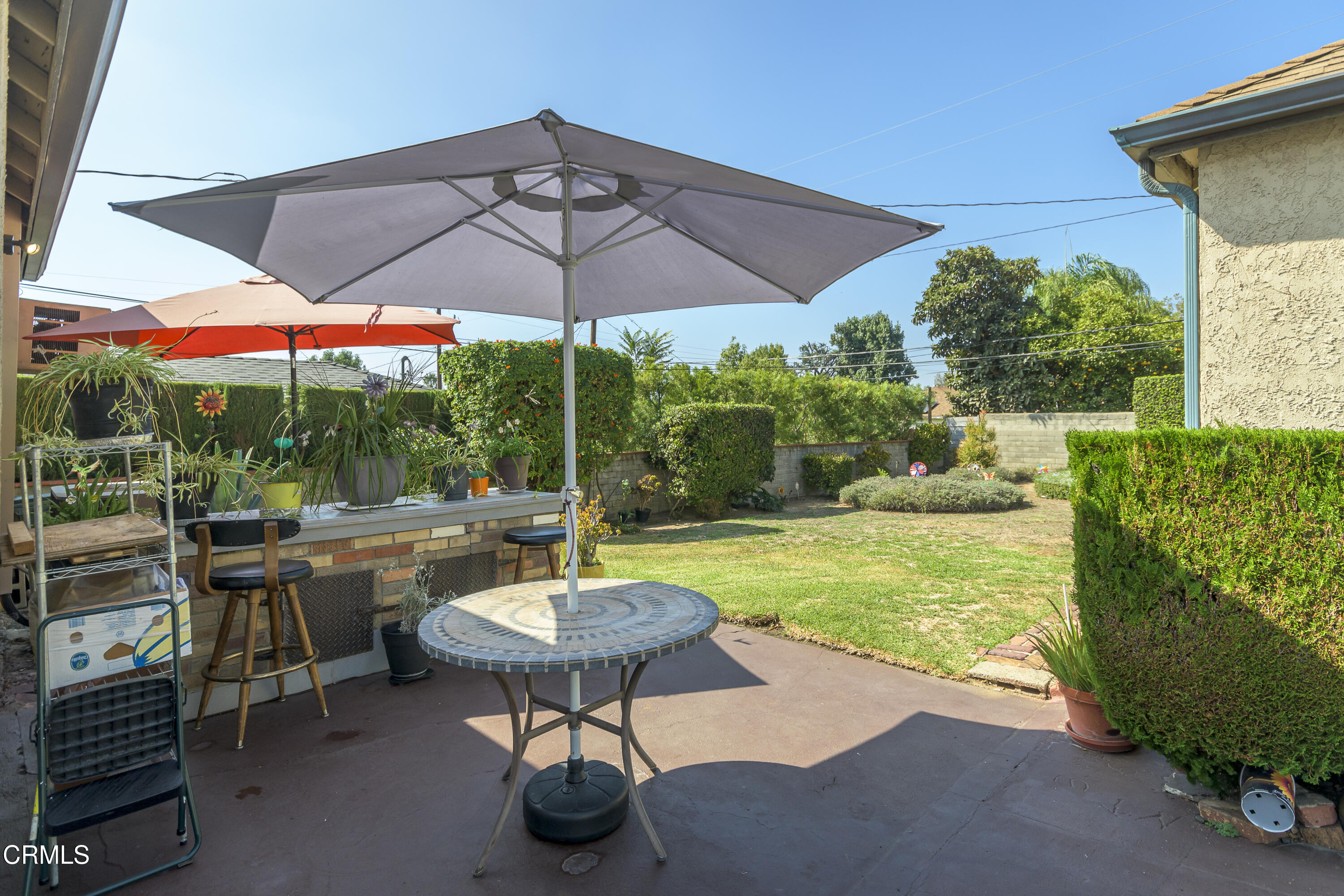 3279 Laurice Avenue Altadena, CA 91001 - Photo 23 of 24 a view of a backyard with table and chairs under an umbrella
