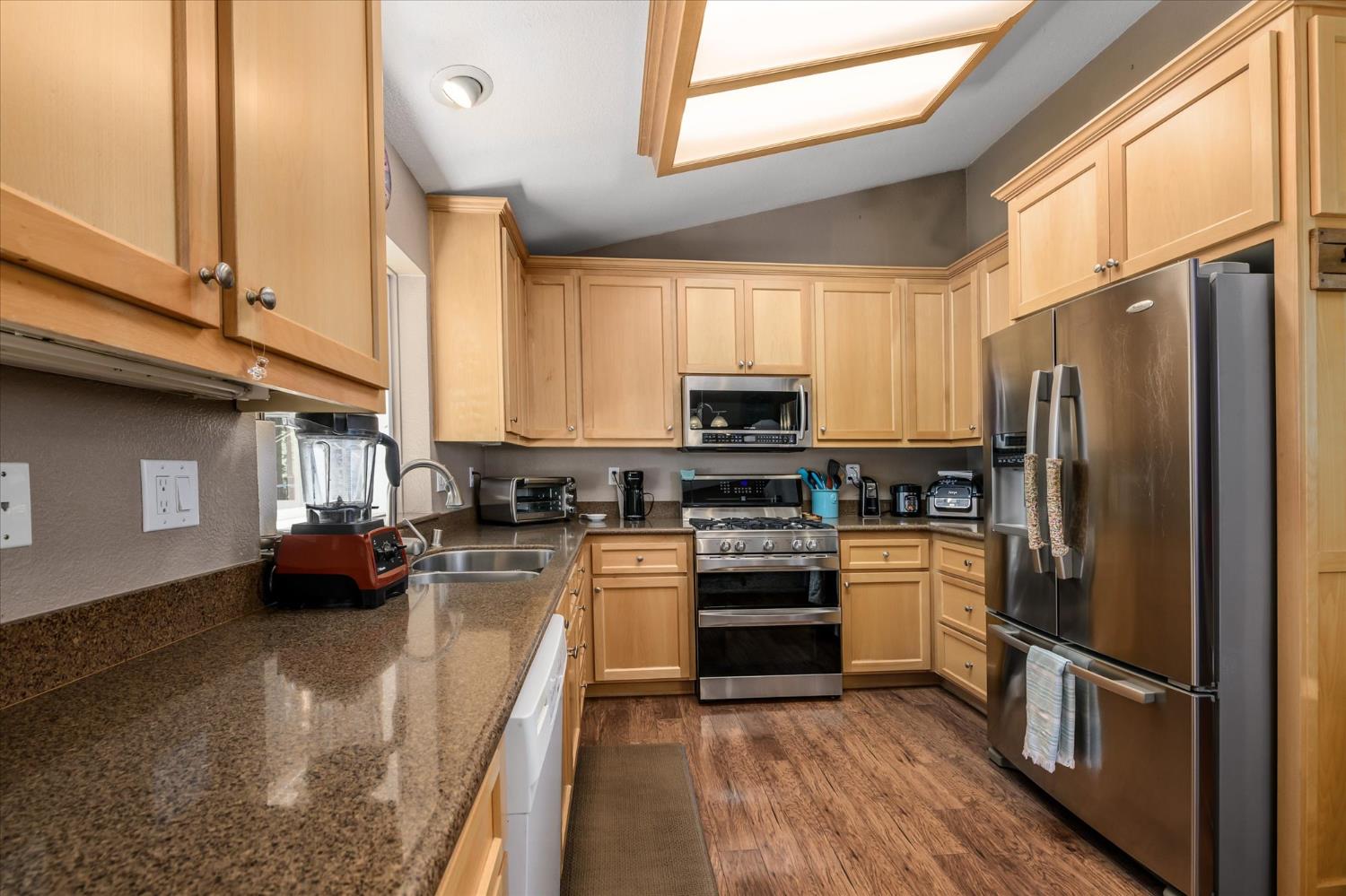 6480 Granite Trail Pollock Pines, CA 95726 - Photo 11 of 23 a kitchen with stainless steel appliances a refrigerator sink and microwave