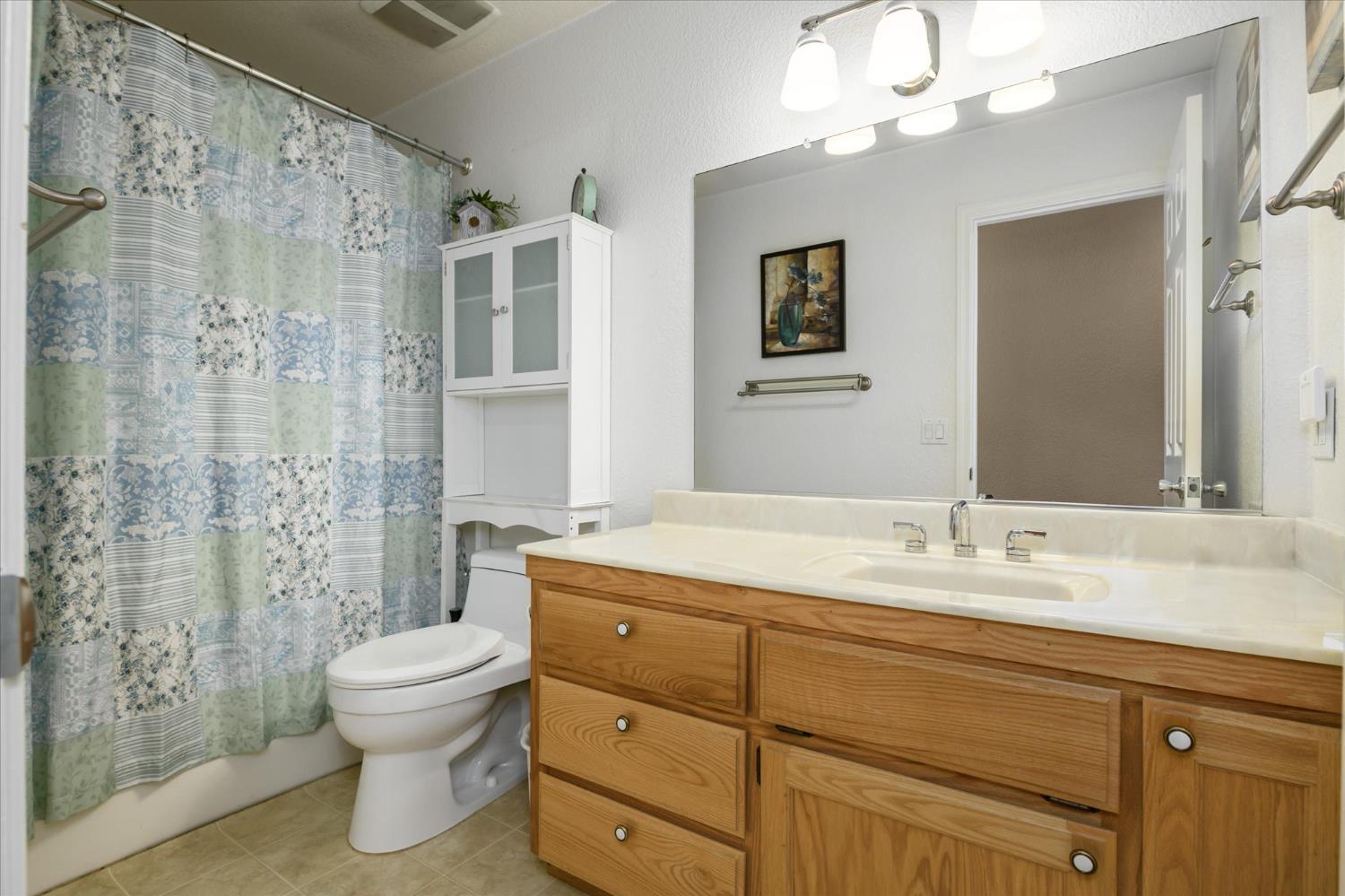 6480 Granite Trail Pollock Pines, CA 95726 - Photo 18 of 23 a bathroom with a granite countertop sink a toilet and a bathtub