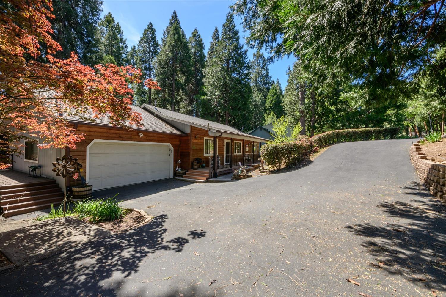 6480 Granite Trail Pollock Pines, CA 95726 - Photo 2 of 23 a wooden house with a large tree in front of it