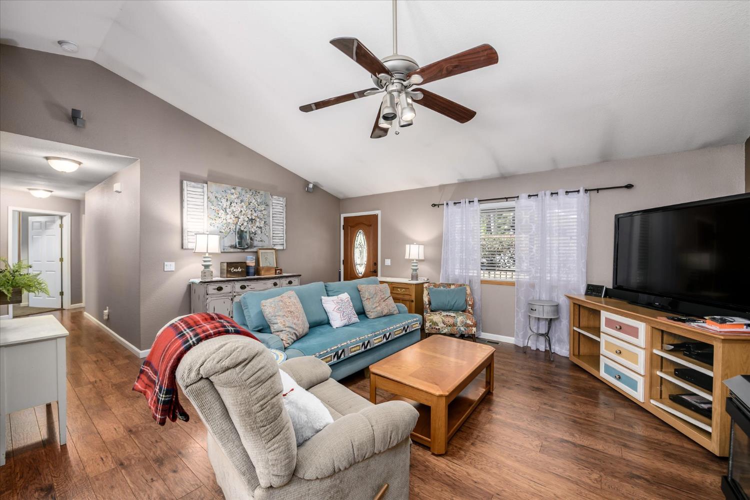 6480 Granite Trail Pollock Pines, CA 95726 - Photo 7 of 23 a living room with furniture and a flat screen tv