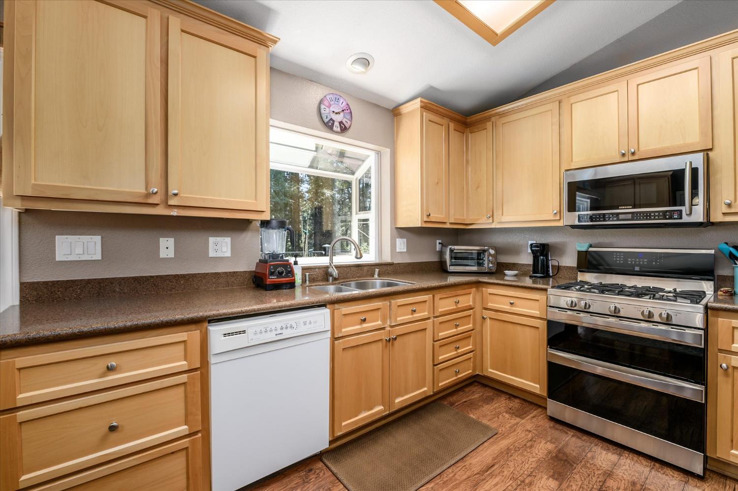 6480 Granite Trail Pollock Pines, CA 95726 - Photo 10 of 23 a kitchen with stainless steel appliances granite countertop a stove a sink and a microwave