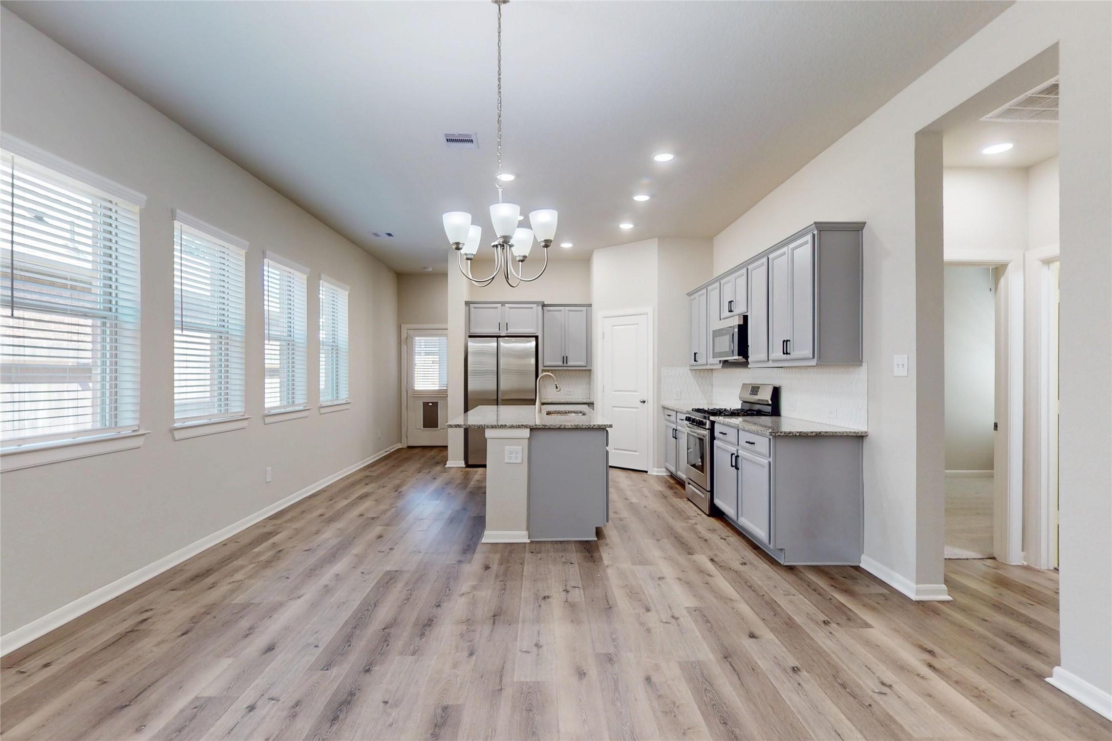 21586 Jordan Pond Ridge Porter, TX 77365 - Photo 7 of 30 Notice the wall of 4 windows that bring light into the kitchen!