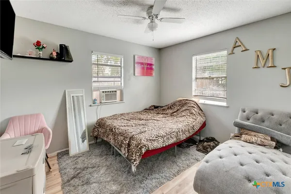 a bedroom with furniture and a window