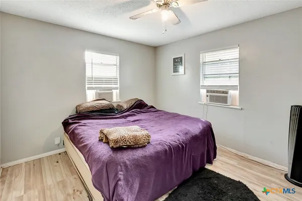 a bedroom with a bed and window