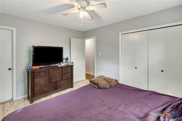 a bedroom with a bed and a flat screen tv