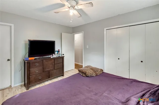 a bedroom with a bed and a flat screen tv