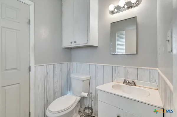 a bathroom with a sink a toilet and vanity