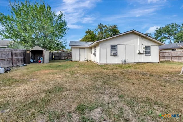 a view of a house with yard and a tree