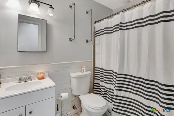 a white toilet sitting next to a bathroom sink