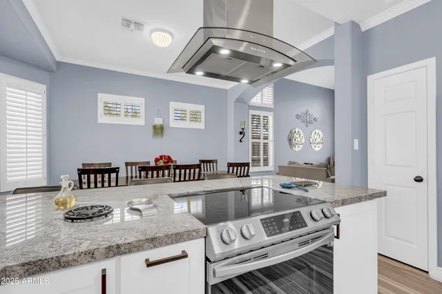 a bedroom with a bed a dresser and a window