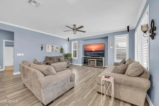 a living room with furniture white walls and wooden floor