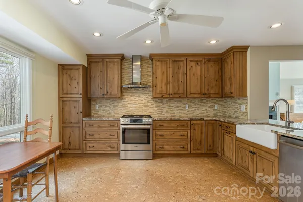 a kitchen with stainless steel appliances granite countertop a sink and cabinets