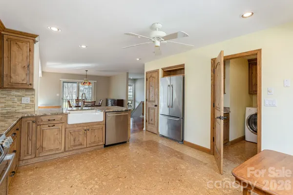 a kitchen with a refrigerator and white cabinets