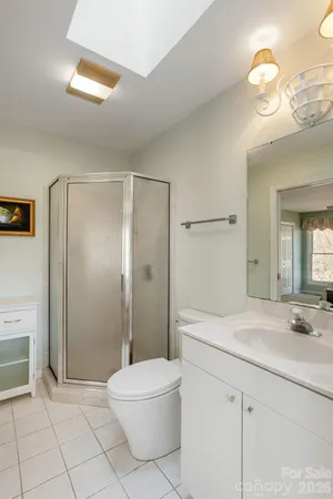 a spacious bathroom with a shower sink and mirror