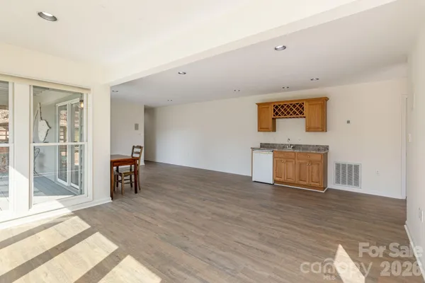 a view of a livingroom with wooden floor and a ceiling fan