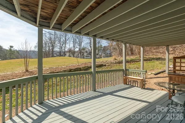a view of a balcony with wooden floor