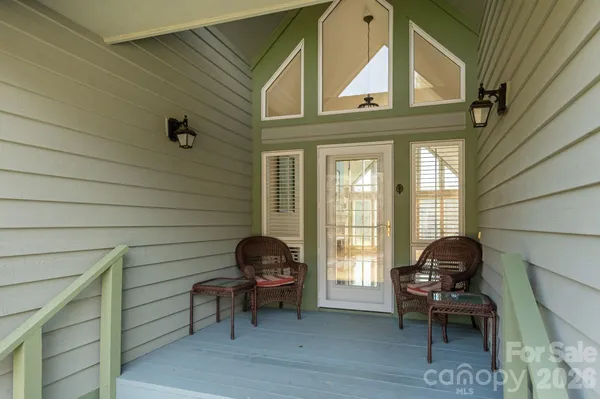 a view of a door and chair in the balcony