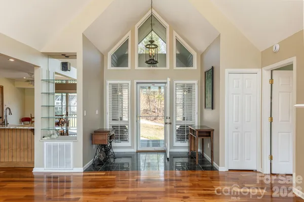 a view of hall way with furniture and floor to ceiling window