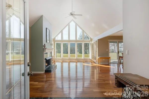 a view of a livingroom with wooden floor and furniture
