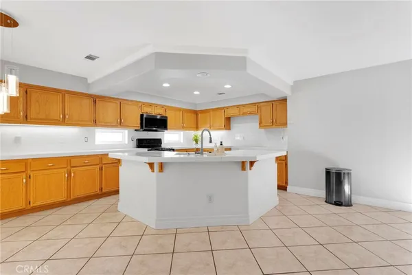 a kitchen with granite countertop cabinets stainless steel appliances and a counter space